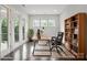Bright home office featuring French doors, a wooden desk, a bookshelf, and natural light at 13102 Indigo Run Ct, Charlotte, NC 28278