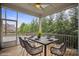 Screened porch with outdoor dining table and view of the tree line at 13102 Indigo Run Ct, Charlotte, NC 28278