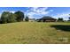 Picturesque backyard featuring a lush green lawn and partial view of home with detached garage at 1351 Hardin Rd, Dallas, NC 28034