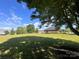 Large backyard with established landscaping and brick home exterior at 1351 Hardin Rd, Dallas, NC 28034
