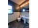 Cozy bathroom featuring beadboard, pedestal sink and dark floors at 1351 Hardin Rd, Dallas, NC 28034