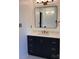 Bathroom vanity with a navy blue cabinet, gold hardware, and a marble countertop at 1351 Hardin Rd, Dallas, NC 28034