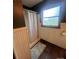 A clean and simple bathroom featuring a shower with a white curtain and wainscotting at 1351 Hardin Rd, Dallas, NC 28034