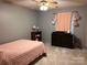 Bedroom with a pink quilt, a ceiling fan, and dark wood furniture at 1351 Hardin Rd, Dallas, NC 28034