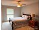 Cozy bedroom with a decorative quilt, a ceiling fan, and bedside tables with lamps at 1351 Hardin Rd, Dallas, NC 28034