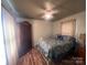 Cozy bedroom with vintage armoire, white metal bed frame, and ceiling fan at 1351 Hardin Rd, Dallas, NC 28034