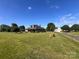 Charming home featuring a well-maintained lawn, mature trees, and detached garage at 1351 Hardin Rd, Dallas, NC 28034