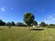 Wide shot of the lawn and home with mature tree in foreground at 1351 Hardin Rd, Dallas, NC 28034