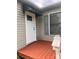 Cozy porch boasts a painted wood deck and a white storm door, protected by a green awning at 1351 Hardin Rd, Dallas, NC 28034