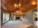 Inviting living room features a brick fireplace, built-in bookcases, and a vaulted wood ceiling at 1351 Hardin Rd, Dallas, NC 28034