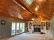 Inviting living room features a brick fireplace, built-in bookcases, and a vaulted wood ceiling at 1351 Hardin Rd, Dallas, NC 28034
