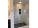 Walk-in shower featuring marble-style tile, a glass enclosure, and a built-in niche at 1351 Hardin Rd, Dallas, NC 28034