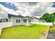 Grassy backyard with a covered patio and white privacy fence at 13702 Tranquil Day Dr, Matthews, NC 28105