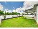 Spacious backyard featuring a covered patio, landscaping, and white privacy fence at 13702 Tranquil Day Dr, Matthews, NC 28105