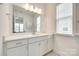 Bathroom with a large mirror, white vanity, and ample storage space at 13702 Tranquil Day Dr, Matthews, NC 28105