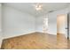 Large bedroom with hardwood floors leading to a bright en-suite bathroom at 13702 Tranquil Day Dr, Matthews, NC 28105