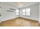 This bedroom has hardwood floors, multiple windows, and dual floating shelves that add visual interest at 13702 Tranquil Day Dr, Matthews, NC 28105