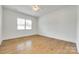 Bright bedroom featuring natural light, neutral paint, and hardwood floors at 13702 Tranquil Day Dr, Matthews, NC 28105