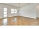 Dining Room featuring hardwood floors, a modern light fixture, and a door that leads to the exterior at 13702 Tranquil Day Dr, Matthews, NC 28105