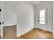 Bright entryway with hardwood floors and a view into an adjacent room at 13702 Tranquil Day Dr, Matthews, NC 28105