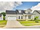 Charming home with two-car garage, dormer window, landscaping, and a covered porch at 13702 Tranquil Day Dr, Matthews, NC 28105