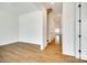 Bright hallway featuring hardwood floors and access to multiple rooms at 13702 Tranquil Day Dr, Matthews, NC 28105