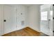 Hallway with hardwood floors, base trim, an air vent, and access to a bright room with lots of natural light at 13702 Tranquil Day Dr, Matthews, NC 28105