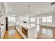 Open concept kitchen with stainless steel appliances, an island with a microwave, and wood floors at 13702 Tranquil Day Dr, Matthews, NC 28105