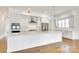 A kitchen features white cabinets, stainless steel appliances, and a large island at 13702 Tranquil Day Dr, Matthews, NC 28105