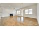 Bright living room features a fireplace, a ceiling fan, a chandelier and hardwood floors at 13702 Tranquil Day Dr, Matthews, NC 28105
