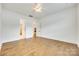 Large bedroom with hardwood floors leading to en-suite bathroom and closet at 13702 Tranquil Day Dr, Matthews, NC 28105