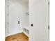 Mudroom with storage bench, hooks, and hardwood floors at 13702 Tranquil Day Dr, Matthews, NC 28105