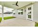 A covered patio with a ceiling fan and access to backyard at 13702 Tranquil Day Dr, Matthews, NC 28105