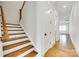 The staircase has stained wood treads, white risers, and is bathed in natural light from the adjacent hallway at 13702 Tranquil Day Dr, Matthews, NC 28105