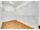 Walk-in closet featuring modern wire shelving and hardwood floors at 13702 Tranquil Day Dr, Matthews, NC 28105