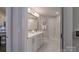 Elegant bathroom featuring double sinks, white cabinetry, a large mirror, and a walk-in shower at 148 Adelaide Way, Rock Hill, SC 29732