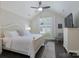 Bright bedroom features a white bed set, vaulted ceilings, a ceiling fan and neutral décor at 148 Adelaide Way, Rock Hill, SC 29732