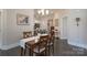 Dining room with wood table set, view to modern kitchen, and dark wood flooring creating an elegant space at 148 Adelaide Way, Rock Hill, SC 29732