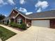 Beautiful brick home with a well-maintained lawn, garage, and attractive landscaping at 148 Adelaide Way, Rock Hill, SC 29732