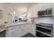 Stylish kitchen with stainless appliances, granite countertops, and view to living room, perfect for entertaining at 148 Adelaide Way, Rock Hill, SC 29732