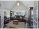 Spacious living room featuring vaulted ceilings, large windows, hardwood floors, and comfortable leather furniture at 148 Adelaide Way, Rock Hill, SC 29732