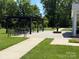 Community patio area with pergola, outdoor seating, and a decorative water fountain, perfect for relaxation at 148 Adelaide Way, Rock Hill, SC 29732