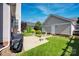Secluded backyard features a grill, seating, and view of the detached garage at 15430 Waterfront Dr, Huntersville, NC 28078