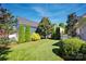 Lush, manicured backyard with green lawn and mature landscaping provides privacy at 15430 Waterfront Dr, Huntersville, NC 28078