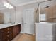 Elegant bathroom features a glass enclosed shower and granite vanity with dark wood cabinets at 15430 Waterfront Dr, Huntersville, NC 28078