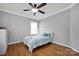 Neutral bedroom with a ceiling fan and natural light at 15430 Waterfront Dr, Huntersville, NC 28078