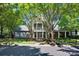 Community clubhouse framed by mature shade trees, features white columns and a balcony at 15430 Waterfront Dr, Huntersville, NC 28078