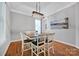Bright dining room with modern light fixture, wood floors, and neutral wall paint at 15430 Waterfront Dr, Huntersville, NC 28078