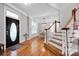 Inviting entry hall with hardwood floors and staircase, leading to dining area and other rooms at 15430 Waterfront Dr, Huntersville, NC 28078