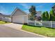 Detached two car garage with white door is set back from the main house at 15430 Waterfront Dr, Huntersville, NC 28078